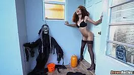 black hottie sucks massive cock through halloween gloryhole