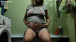 Oh My! Pregnant 19-Year-Old Fingers Shaved Pussy in Bathroom!