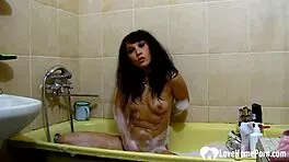 horny brunette fingers pussy in steamy solo bath