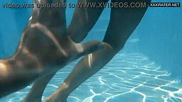 Irina Cage, that busty Russian babe, dives underwater with her blonde friend in the outdoor public area.