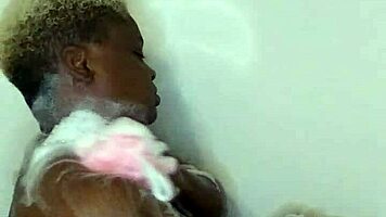 Young ebony babe enjoys a relaxing bath time massage with sensual touches.