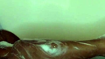 Young ebony babe enjoys a relaxing bath time massage with sensual touches.