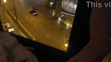 sharing private pleasure outdoors by hotel window