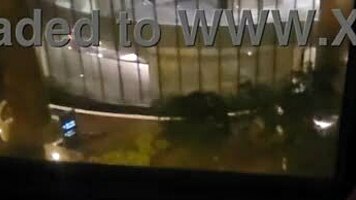sharing private pleasure outdoors by hotel window