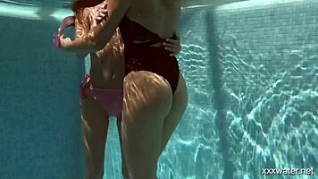 stefanie moon and vyvan hill splashing underwater in pool