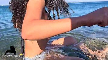 brunette teases boyfriend with beach pissing