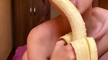 Hot brunette enjoys sucking banana