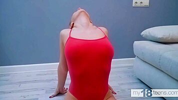 my18teen 18+s flexible and titted girl in a red bodysuit spreads her legs wide and shows her pussy masturbation fingering.