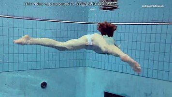 Nastya volna swims gracefully underwater like a wave in the pool