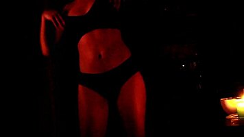 she dances in the dark, slowly removing her panties