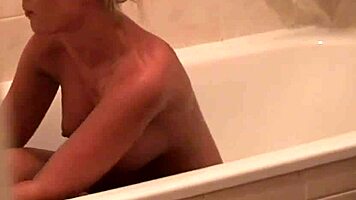 Solo Blonde Babe Showers and Pleasures Her Shaved Pussy