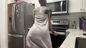 Young 18+ thug with tattoo twerks big ass in kitchen shorts, hairless close-up amateur dancing