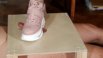 Domina in pink boots stomps her slave with cruel precision