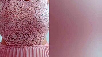 This pretty girl in pink dress plays with her huge natural tits at home!