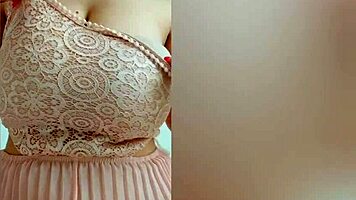 This pretty girl in pink dress plays with her huge natural tits at home!