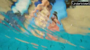 bubarek and birtakik splash and tease each other underwater in the pool, brunette teens in bikinis