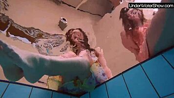 bubarek and birtakik splash and tease each other underwater in the pool, brunette teens in bikinis