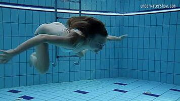 look at clara's small tits underwater in the pool