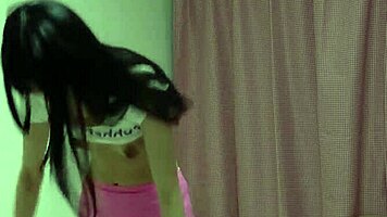 Skinny Japanese girl strips in tight clothes on webcam, revealing her naked body.