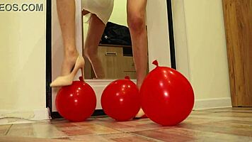 brunette amateur crushes balloons with heels in miniskirt