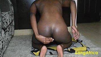 this petite ebony girl is playing with her ass, fingering and anal stuff