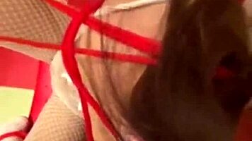 Stunning teen brunette in a tightCORSET:], wearing bondage restraints and cat ears costume performs a fake blowjob