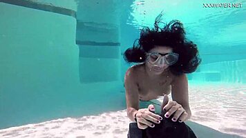 Brita piskova pleasures herself underwater in the pool, showing tits and ass