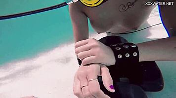 Brita piskova pleasures herself underwater in the pool, showing tits and ass