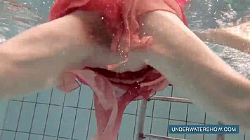 Katya okuneva bathes in pool wearing red dress