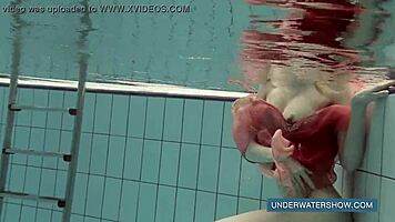 Katya okuneva bathes in pool wearing red dress