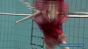 Katya okuneva bathes in pool wearing red dress
