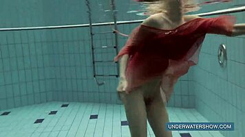 Katya okuneva bathes in pool wearing red dress