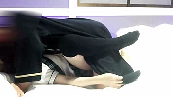 Asian couple in uniform cosplay kisses and fucks on bed