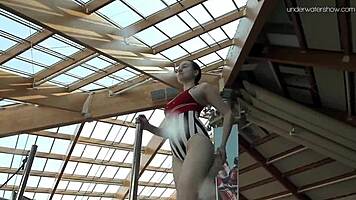 Lada Poleshuk bathes hot in pool, wet and underwater.