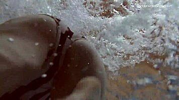 Lada Poleshuk bathes hot in pool, wet and underwater.