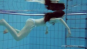 Roxalana swims in pool exposing tight pussy