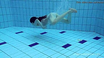 Roxalana swims in pool exposing tight pussy