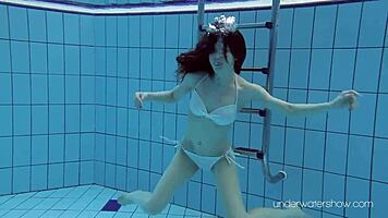 Roxalana swims in pool exposing tight pussy