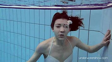 Roxalana swims in pool exposing tight pussy