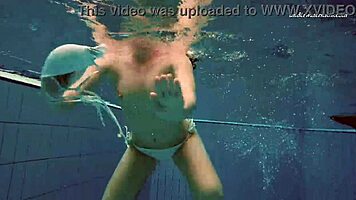 Petite 18+ brunette pornstar Alla swims naked in the hot pool, showing off her horny tits and ass while smoking