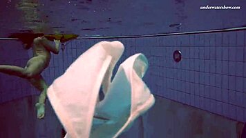 Petite 18+ brunette pornstar Alla swims naked in the hot pool, showing off her horny tits and ass while smoking