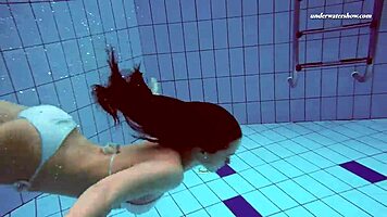 Petite 18+ brunette pornstar Alla swims naked in the hot pool, showing off her horny tits and ass while smoking