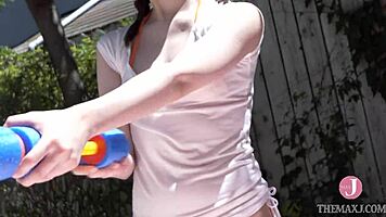 Peerless Beauty Frolics in Water Play Under Clear Sky, Feeling Adorable in Bikini