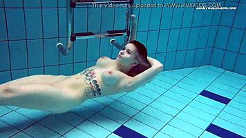Dashka enjoys a beautiful swim in the pool, going from bikini to naked underwater.