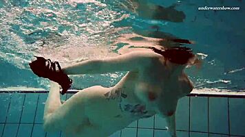 Dashka enjoys a beautiful swim in the pool, going from bikini to naked underwater.