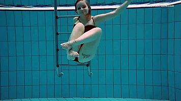 Dashka enjoys a beautiful swim in the pool, going from bikini to naked underwater.