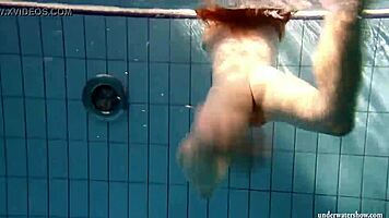 big tits brunette mia strips naked underwater in the pool, showing off her shaved body