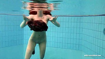 big tits brunette mia strips naked underwater in the pool, showing off her shaved body