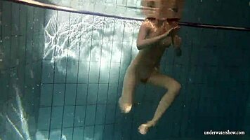 big tits brunette mia strips naked underwater in the pool, showing off her shaved body