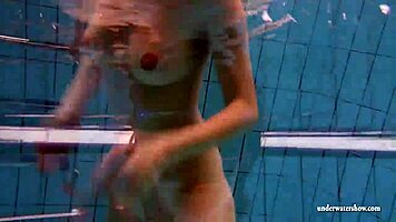 big tits brunette mia strips naked underwater in the pool, showing off her shaved body
